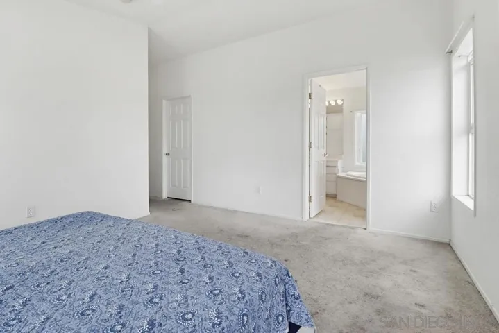 Master bedroom looking into bathroom and walk in closet