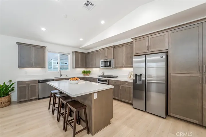 Huge kitchen with handsome wood cabinetry and quartz counters