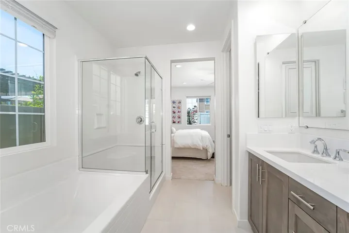 Dual vanity with wood cabinetry and quartz counters