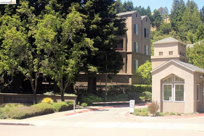 Entry gateway featuring a light-toned stucco finish and arched window details