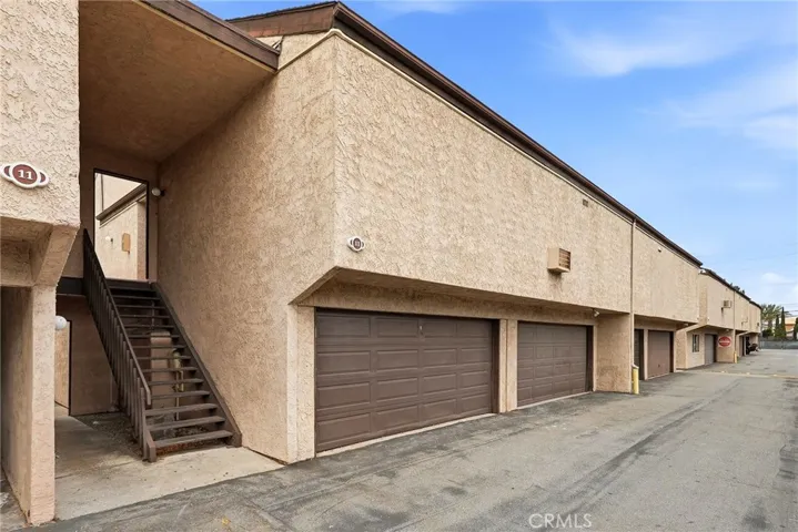 Double car garage of unit and stairs leading to the condo