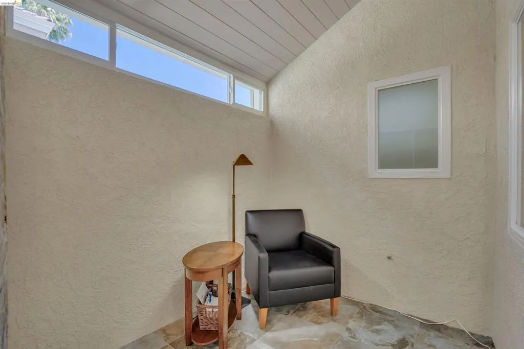 Vaulted ceiling with horizontal paneling and high transom windows