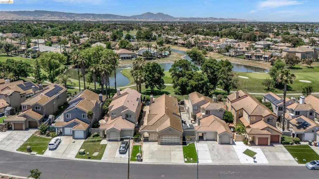 Aerial perspective showcasing a residential community with tile-roofed homes
