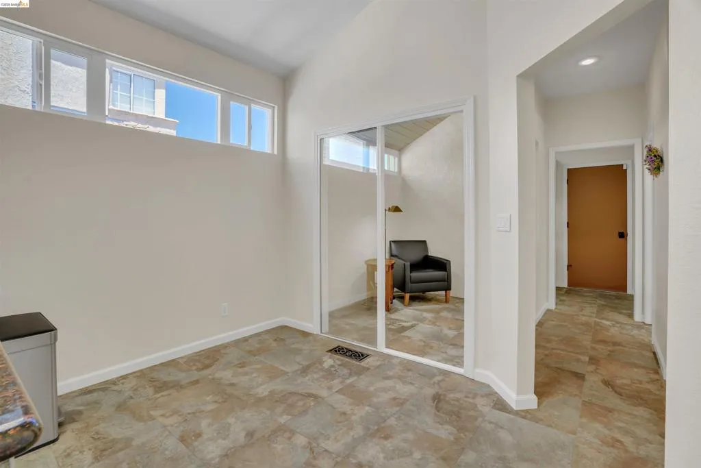 Spacious interior featuring a high vaulted ceiling, clerestory windows, and neutral wall tones