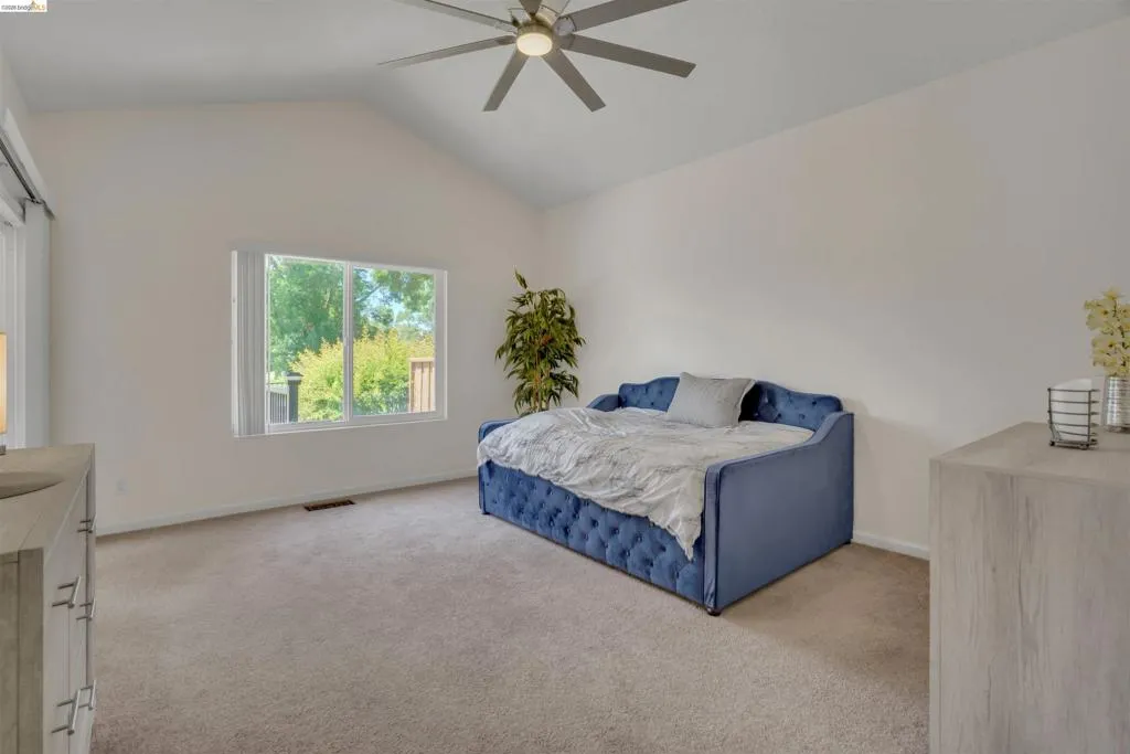 Spacious room with vaulted ceilings and neutral wall tones