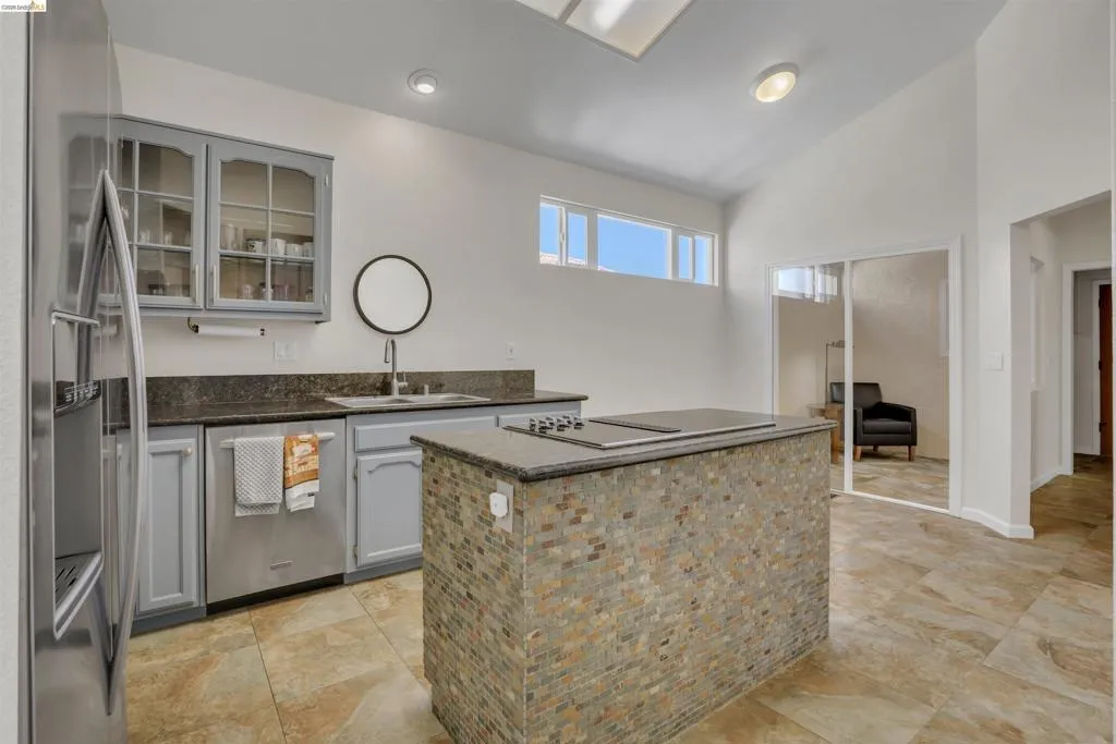 Kitchen with vaulted ceiling, recessed lighting, and a skylight
