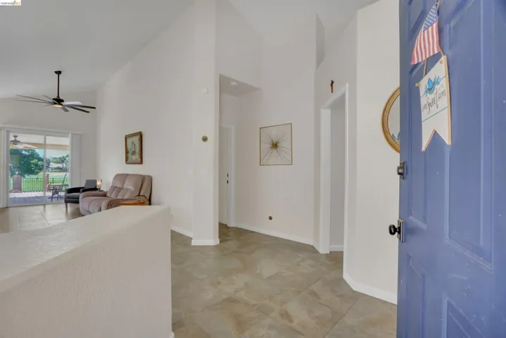 Entry foyer featuring tile flooring and a vibrant blue front door