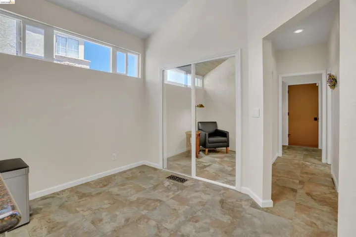 Spacious interior featuring a high vaulted ceiling, clerestory windows, and neutral wall tones