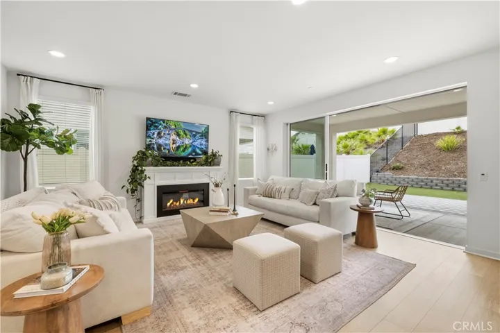 great room with full wall sliding door open to outdoor living space 
