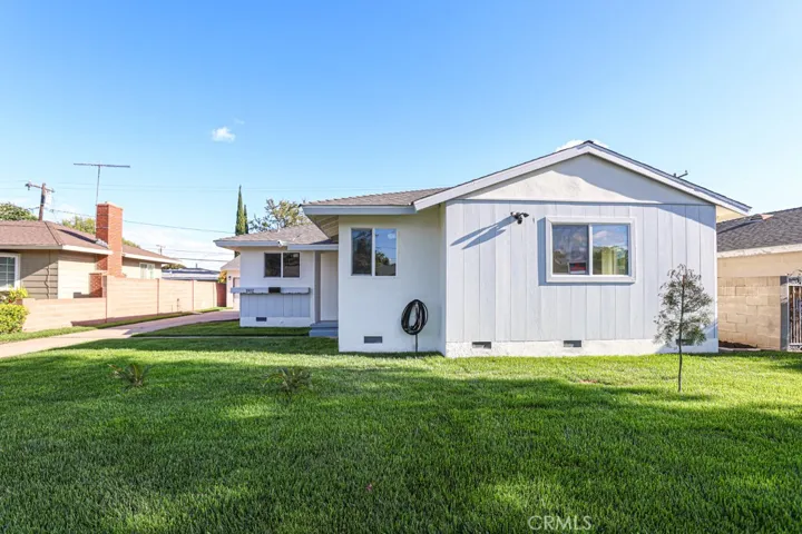 Beautifully remodeled Santa Ana home with fresh curb appeal, new landscaping, and a spacious front lawn.