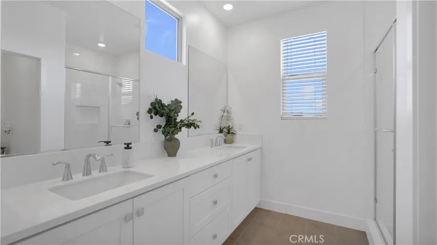Spa like primary bathroom with large double sink vanity.