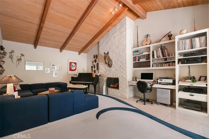 Den with fireplace off sitting area