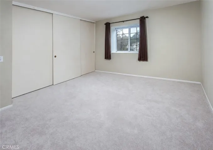 Secondary bedrooms offer generous closet space, including mirrored closet doors in one room.