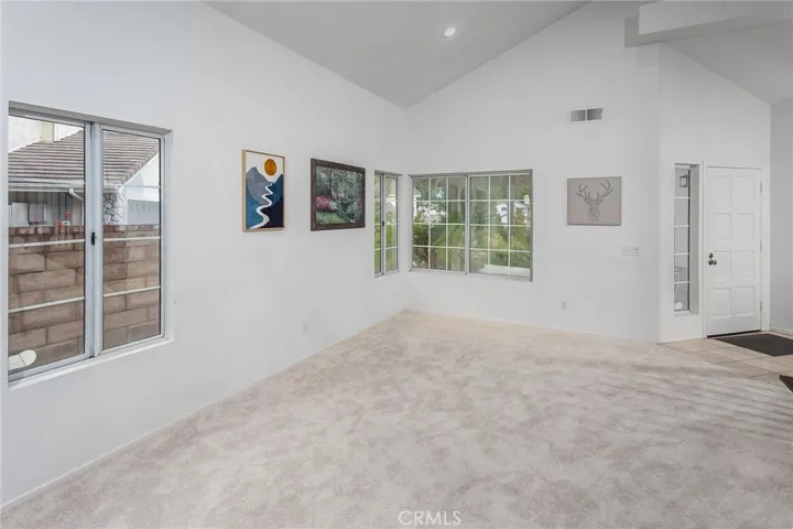 The living room features full color spectrum smart recessed lighting, while new carpet throughout, dual pane windows, central air and heat, and a Nest® thermostat add comfort and efficiency.