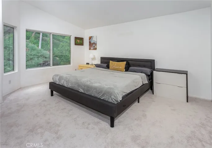 Upstairs, the spacious primary suite features pitched ceilings, natural light, walk-in closet, and en suite bath with dual sinks, soaking tub and shower combination, bidet, and privacy area.