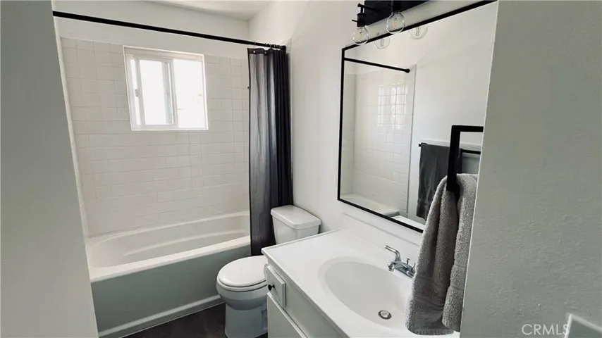 Upstairs bathroom has new mirror, cabinet and flooring.