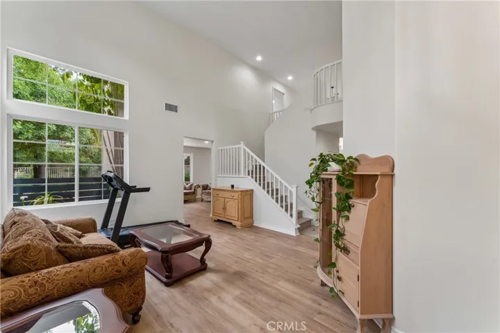 Spacious living room featuring impressive high ceilings, abundant natural light, and a modern open-concept layout.