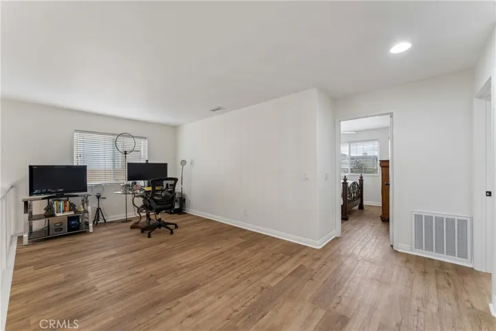 Spacious loft featuring a dedicated gaming area and a versatile home office space.