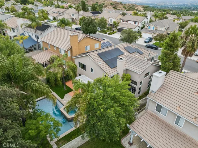 Backyard view featuring solar panels.