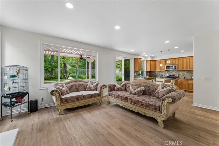 Family room featuring luxury vinyl flooring and a direct view of the backyard.