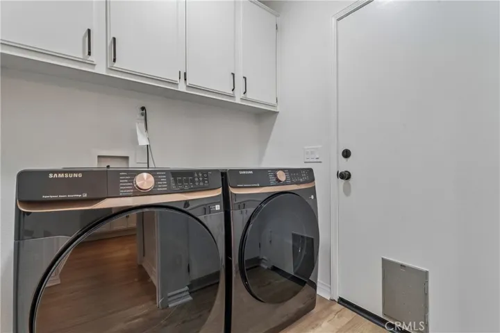 Laundry room featuring built-in cabinetry and a utility sink.