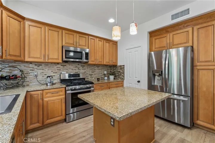 Beautiful gourmet kitchen featuring high-end stainless steel appliances, custom cabinetry, quartz countertops, and a spacious center island perfect for entertaining.