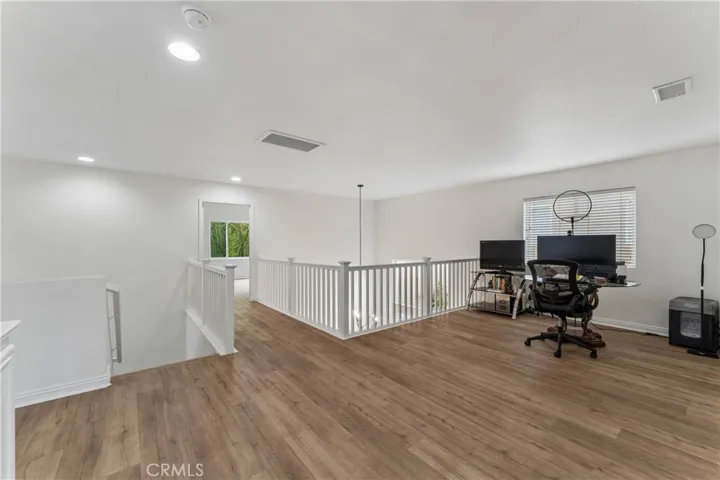 Spacious loft featuring a dedicated gaming area and a versatile home office space.