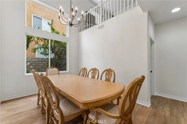 Formal dining room featuring high ceilings and elegant finishes.