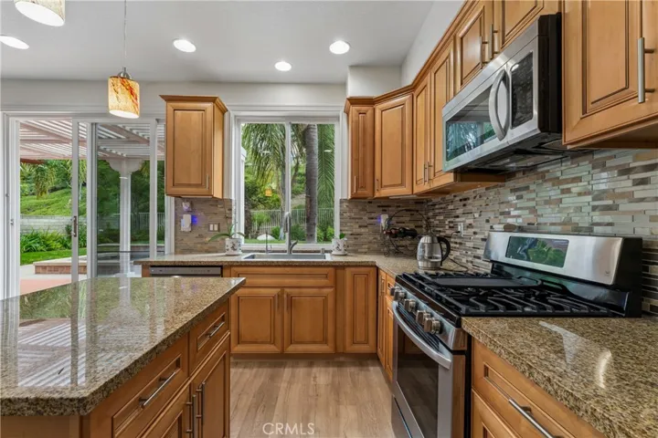Beautiful gourmet kitchen featuring high-end stainless steel appliances, custom cabinetry, quartz countertops, and a spacious center island perfect for entertaining.