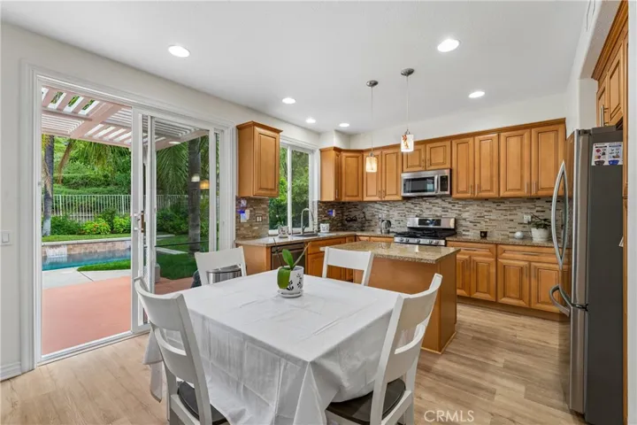 Bright, inviting breakfast area featuring natural light and a seamless flow to the kitchen.