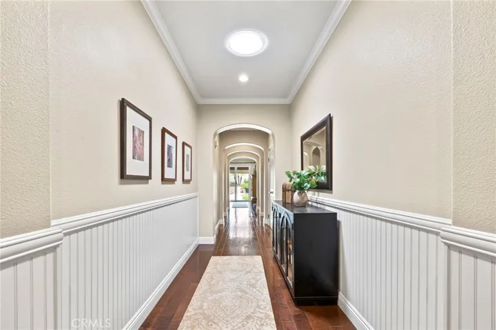 Beautiful entry corridor with Wainscotting, sky lights and wood floors