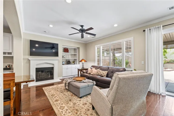 Family room w/ Cozy fireplace and view of backyard