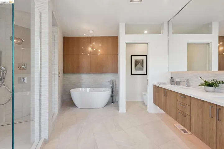Freestanding soaking tub with a modern chandelier fixture