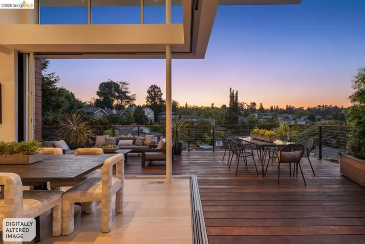 Expansive outdoor deck featuring dark wood planking and cable railing