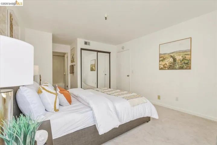 Bedroom featuring light-toned carpeting, white walls, and a recessed ceiling light