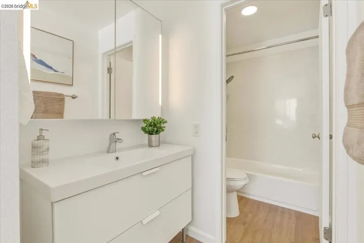 Modern bathroom featuring a white floating vanity with integrated sink and chrome faucet
