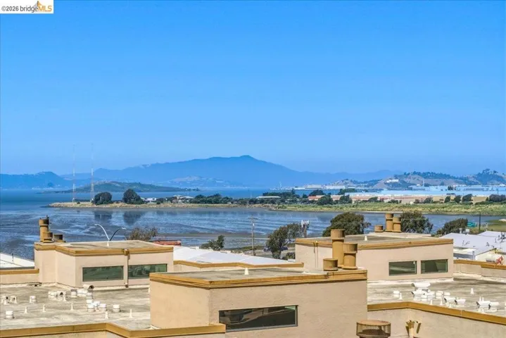 Expansive water frontage with mountain backdrop