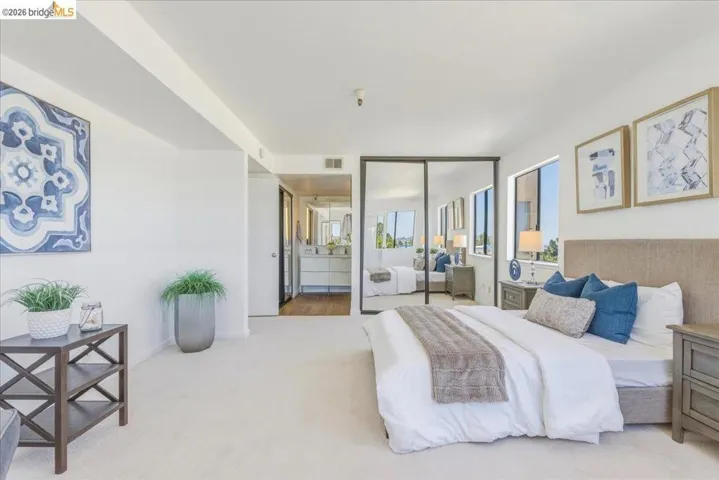 Bright bedroom featuring carpeted flooring and white walls