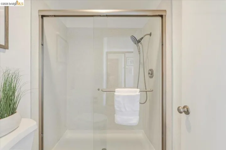 Clear glass shower enclosure with brushed nickel framing and hardware