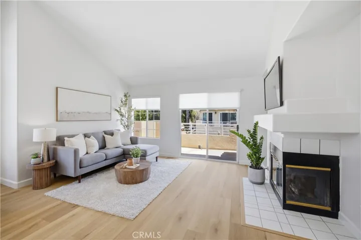 Living room has luxury vinyl floors, custom paint and roller shades.