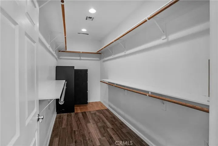 Primary bedroom walk in closet with safe