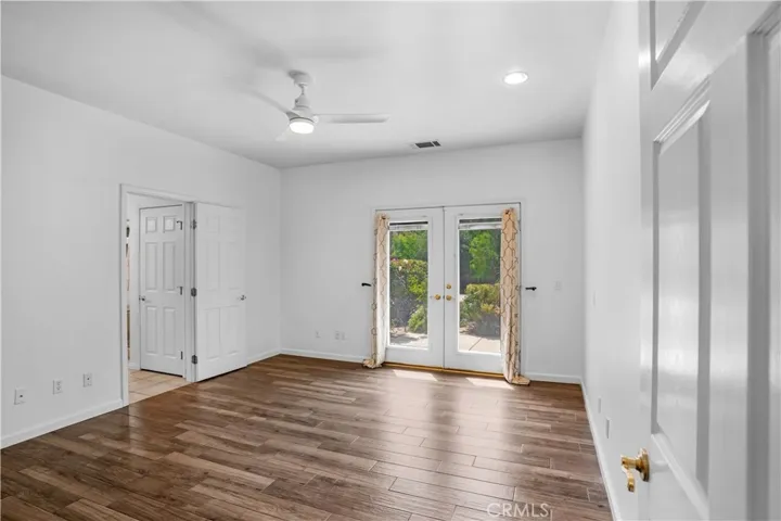 Primary bedroom with doors opening to front courtyard