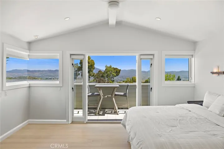 French doors lead to the balcony off the primary suite with beautiful mountain views.