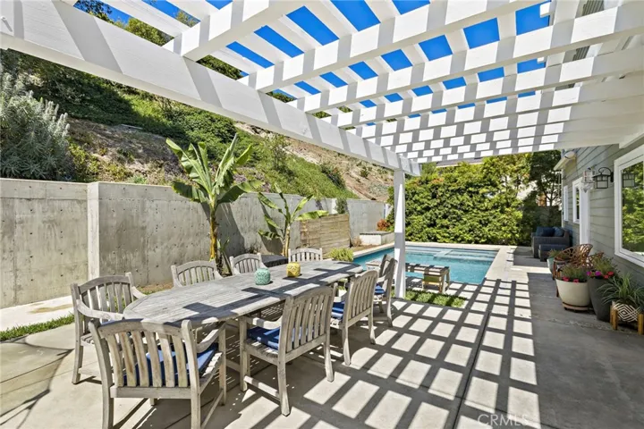  The backyard serves as a private sanctuary, thoughtfully designed for both relaxation and entertaining