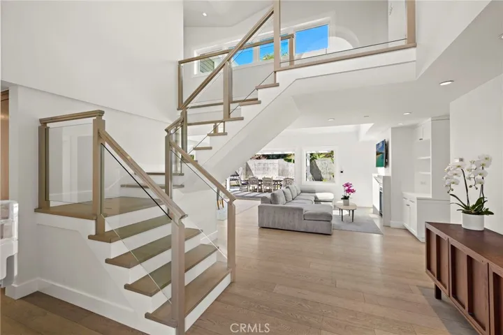 Enter into soaring ceilings and a light-filled living room, with stunning skylights, custom built-ins, and one of the home's two fireplaces.