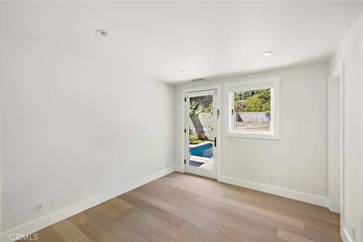 Lower level bedroom with en-suite bath and door that opens to the pool back yard