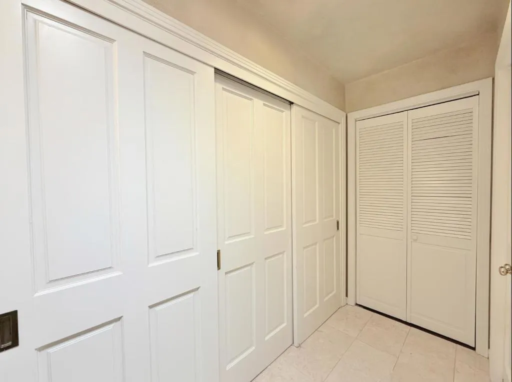Primary bathroom with adjacent closet area.