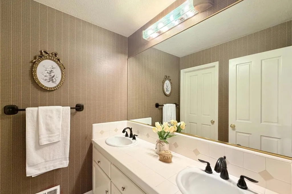 Bathroom with dual-sink vanity.