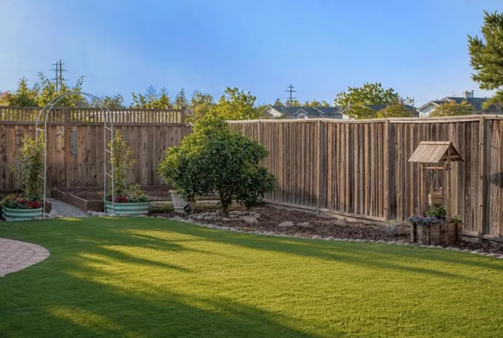 Garden planting area along the backyard fence.