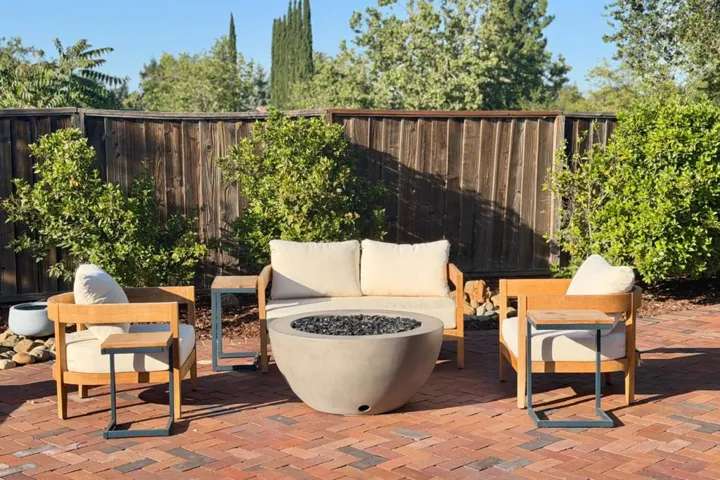 Outdoor fire pit area with patio seating.